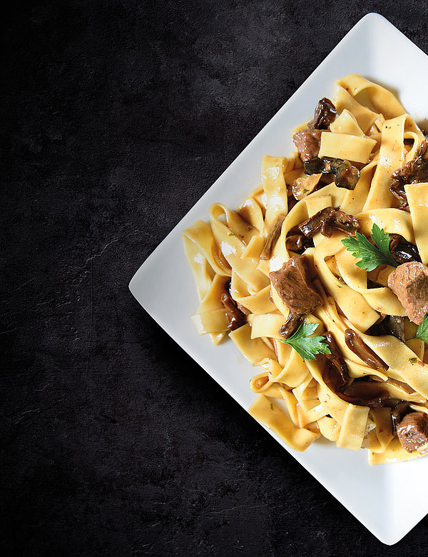 Tagliatelle al vino rosso with beef fillet tips and king trumpet mushrooms